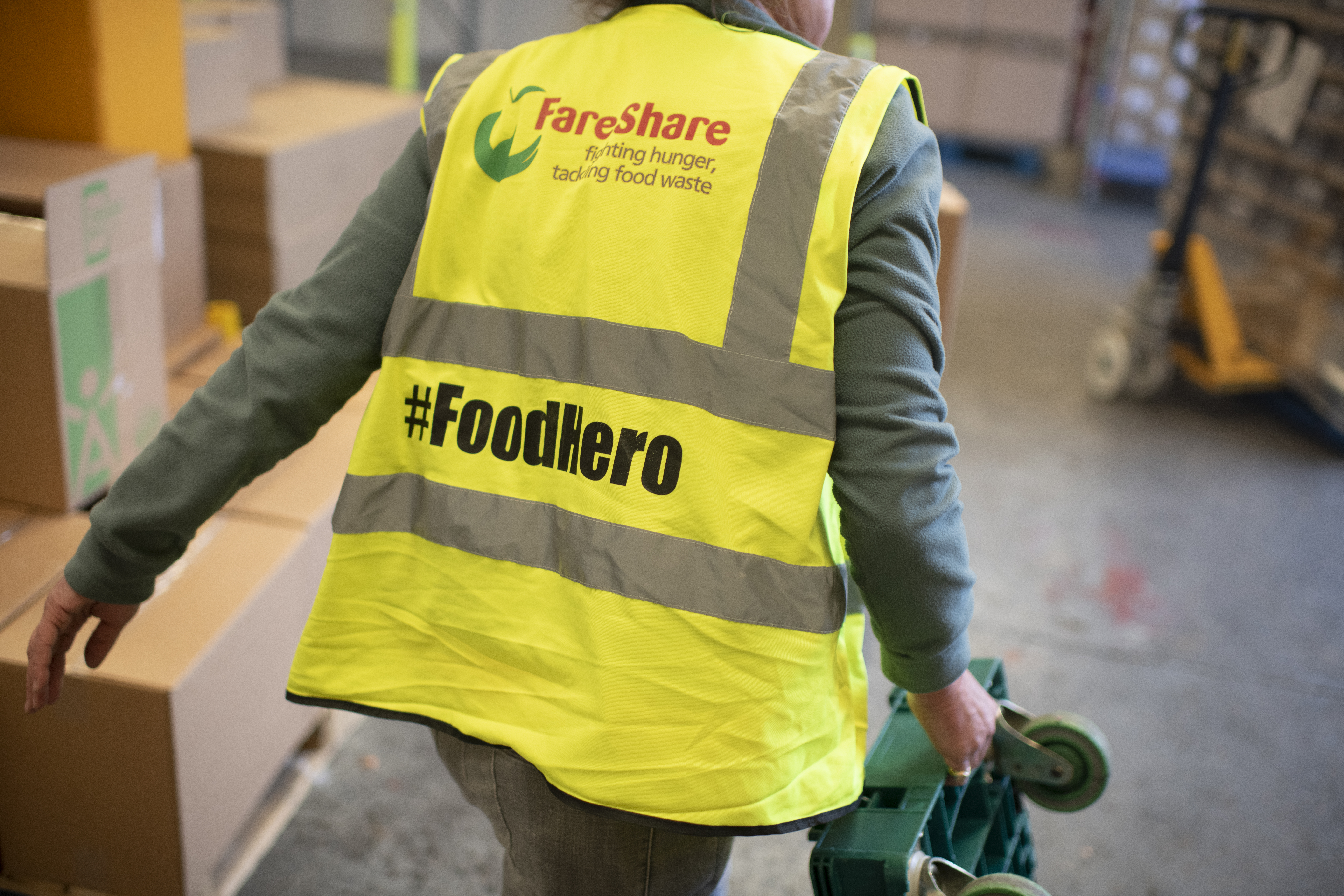 Person in high visibility vest with #FoodHero written on the back