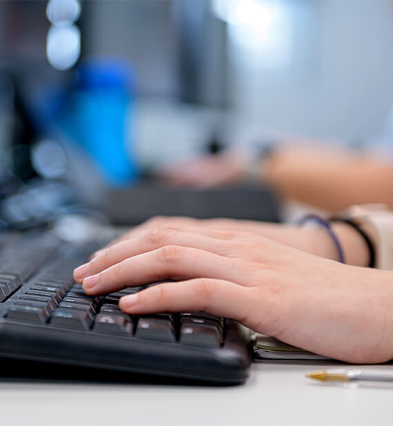 Person typing on a keyboard